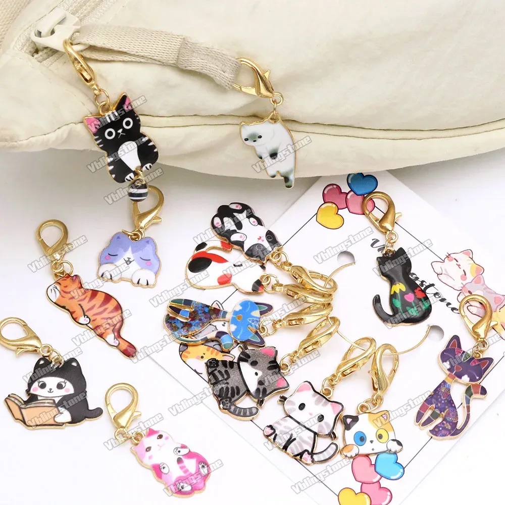 Cat charm stitch markers clipped decoratively onto a canvas project bag